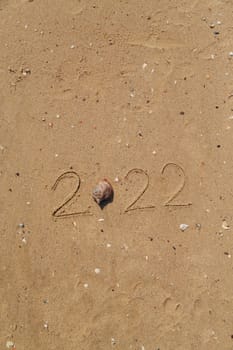 Word 2022 Written on the Sand of a Beach. With Copy Past Space