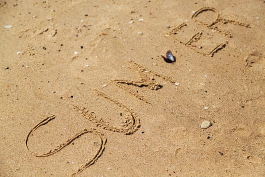 Word Summer Written on the Sand of a Beach. Text on the Golden Sea Beach.