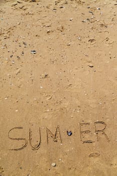 Word Summer Written on the Sand of a Beach. Text on the Golden Sea Beach.