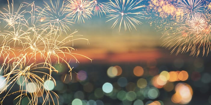 Fireworks and city bokeh lights on twilight sky background with copy space for text. Abstract holiday background
