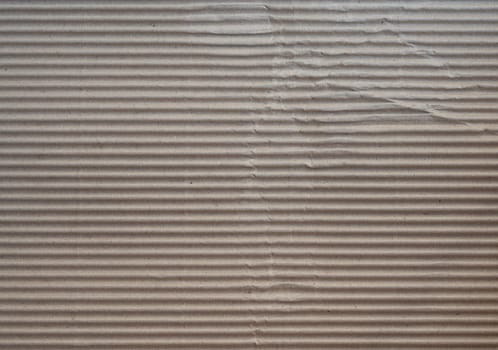 Crumpled brown paper craft texture background of fluted corrugated fiberboard sheet