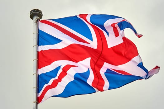 the flag of Great Britain is flying on the flagpole. High quality photo