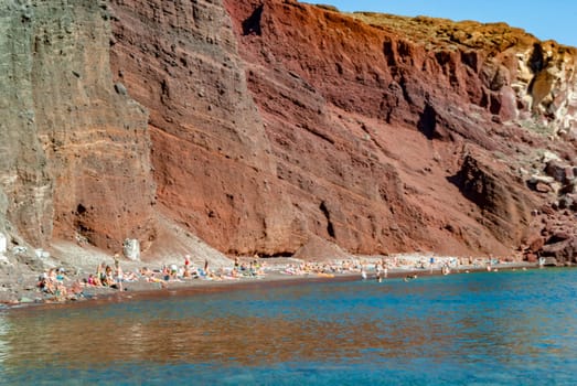 Tourists on the shores of the Red Beach in Santorini.
