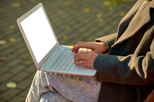 Female hands typing on a laptop keyboard close-up, mockup. High quality photo