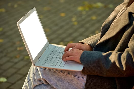 Female hands typing on a laptop keyboard close-up, mockup. High quality photo
