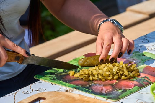 slicing pickles on a cutting board. High quality photo