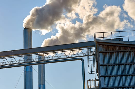 Smoke is coming from the pipe of an industrial enterprise. High quality photo