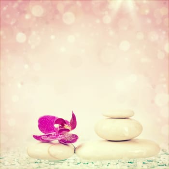 Spa stones and pink flower on white background