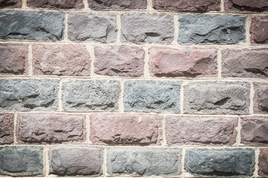 Basalt blocks lined. Close up of a wall of stone.