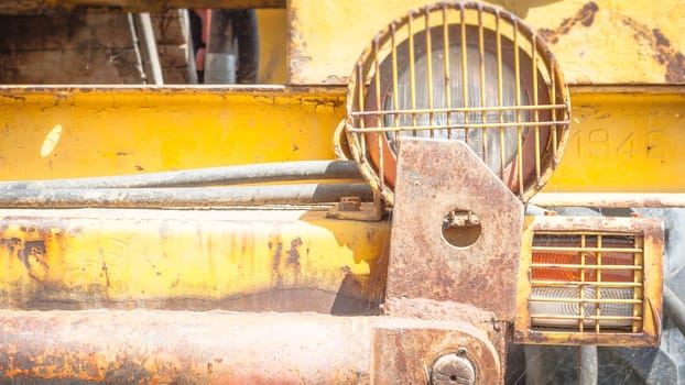 Headlight in an old tractor. Particular of a headlight.