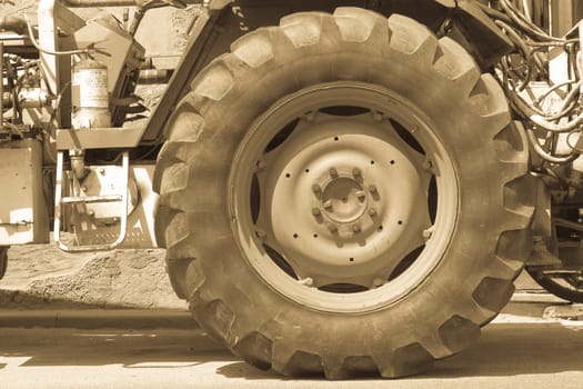 Driving wheel in old tractor. antiqued version .
