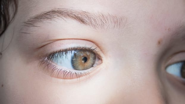 What looks the eye. Close up image of a Kid eye.