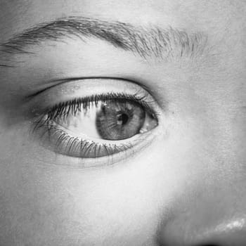 What looks the eye ? Close up image of a Kid eye.