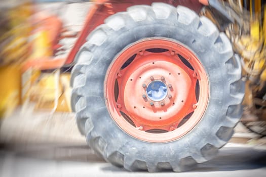 Driving wheel in old tractor. motion blur.