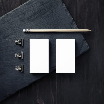 Blank business cards, pencil and clips. Branding mock up. Top view. Flat lay.