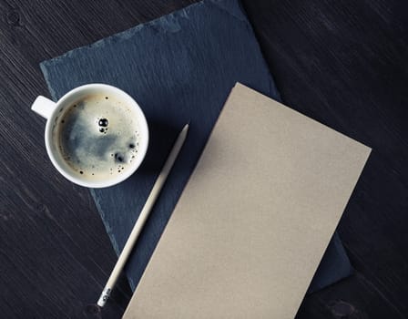 Blank kraft sketchbook, pencil and coffee cup. Stationery template.