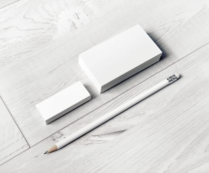 Photo of blank business cards, pencil and eraser. Template for branding identity.