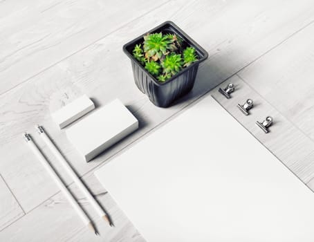 Blank corporate stationery set on light wooden background. Branding identity mock-up.