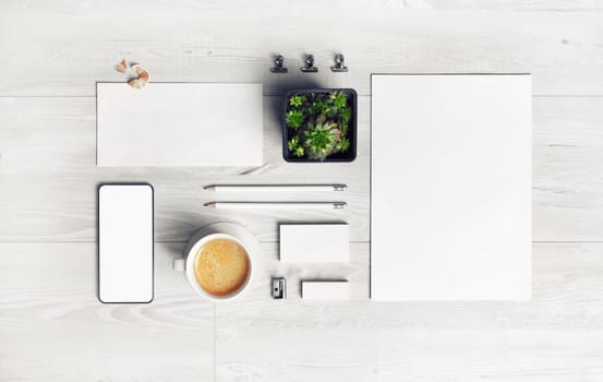 Blank stationery set on light wooden background. For graphic designers presentations and portfolios. Top view. Flat lay.