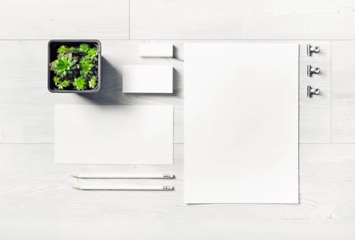 Blank corporate stationery set on light wooden background. Template for branding design. Branding mock up. Top view. Flat lay.