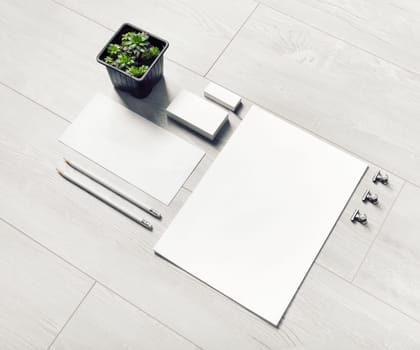 Blank corporate identity template on light wooden background. Photo of blank stationery set.
