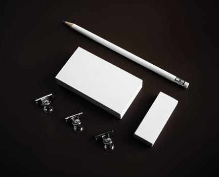 Photo of blank business cards, pencil, eraser and clips. Mockup for ID.