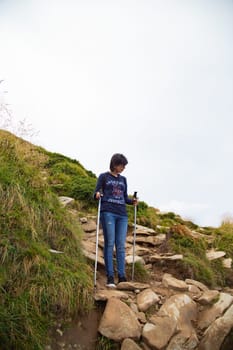 Girl Descend Down a Large Green Mountain Range.