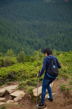 Girl Descend Down a Large Green Mountain Range.
