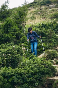 Girl Descend Down a Large Green Mountain Range.