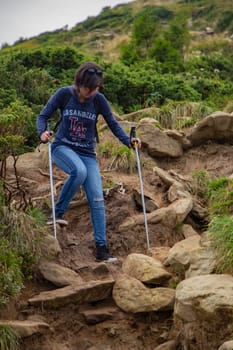 Girl Descend Down a Large Green Mountain Range.