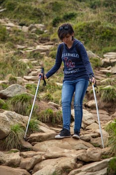 Girl Descend Down a Large Green Mountain Range.