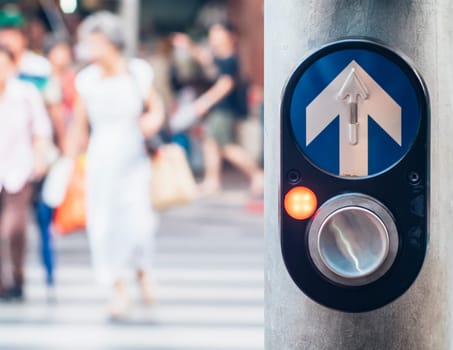 Pedestrian traffic light crossing push button controller in Bangkok Thailand . Car accident campaign idea background. Blurred people across the road in city.