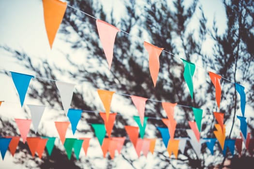 Colorful paper bunting party flags isolated on white background  . Carnival garland with flags. Decorative colorful party pennants for birthday celebration, festival and fair decoration. Holiday