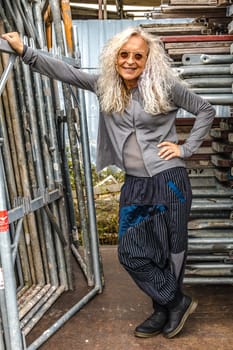 Stylish Lady with long curly hair surround industry area.