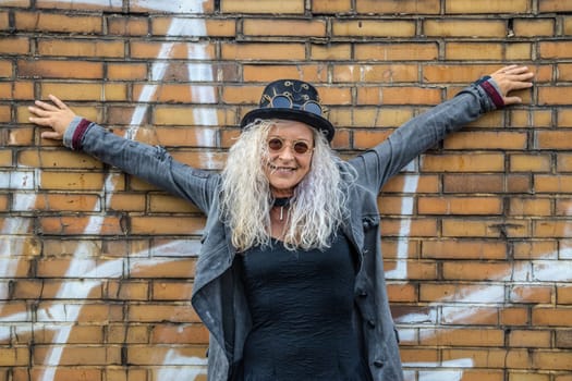 Beautiful Steam Punk Lady standing on a Brick Wall Background