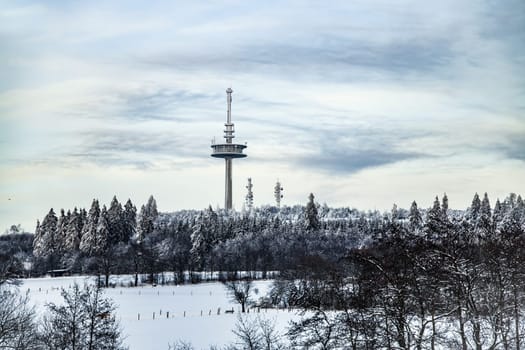 View to Hoherodskopf in beautiful landscape with snow in Hesse Germany
