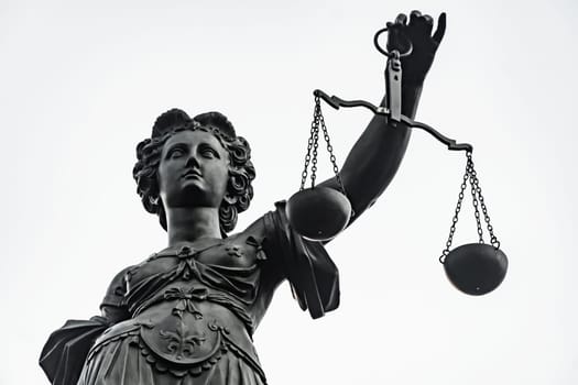Symbol of Justizia figure in Frankfurt isolated over bright background