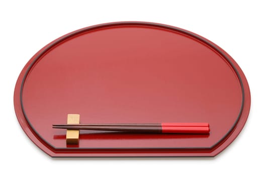 Wooden chopsticks on red lacquer tray with chopstick rest, Isolated on white background