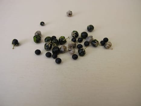 Asparagus seeds, fruits and black seed pods on a wooden board