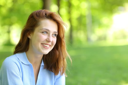 Beautiful happy woman looking away in a park