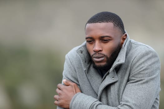 Man with black skin getting cold outdoors in winter