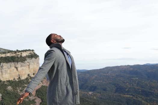 Man with black skin breathing fresh air in winter