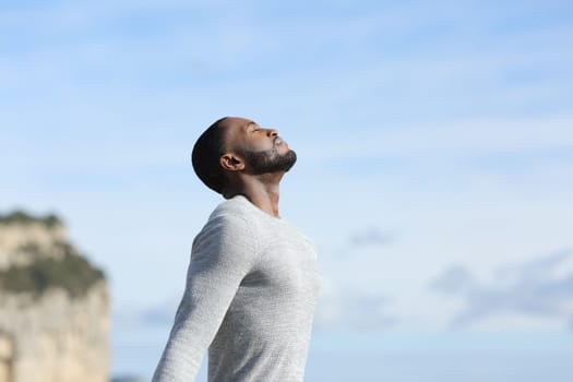 Man with black skin relaxing breathing fresh air outside
