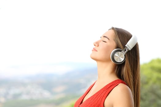 Teenager breathing fresh air wearing wireless headphones