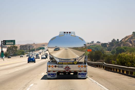 LOS ANGELES, USA - JULY 06:  Reflection of a car in a chrome truck transporting liquids on the highway on July 06, 2008 in Los Angeles, USA.