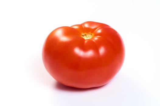 Juicy red tomato on a white isolated background. High quality photo