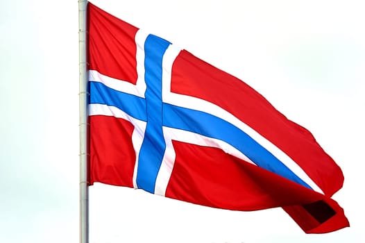 The flag of Norway hangs on the flagpole. High quality photo