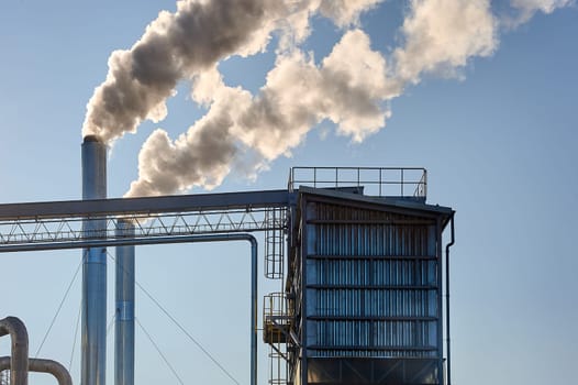 Smoke is coming from the pipe of an industrial enterprise. High quality photo