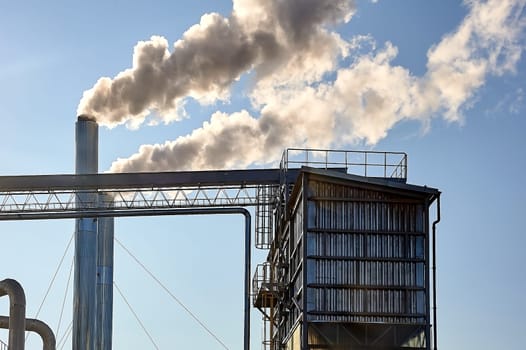 Smoke is coming from the pipe of an industrial enterprise. High quality photo