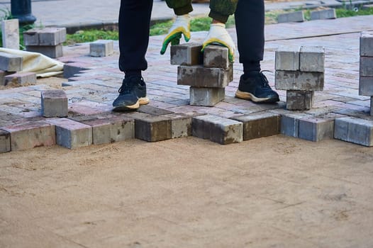 laying paving slabs on the sand with your hands. High quality photo